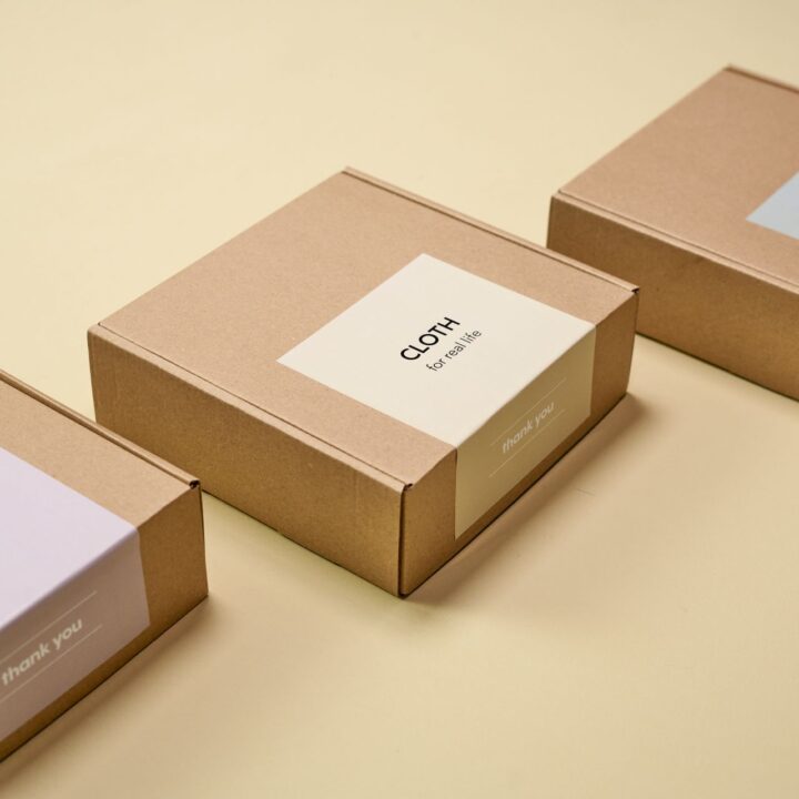 Kraft boxes with printed labels on a cream background