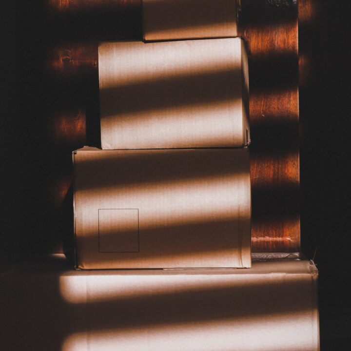 Stacked cardboard boxes in striped light